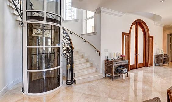 Pneumatic Vacuum Elevator next to a stairway in a luxury home